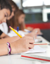 High School Students Writing At Desk