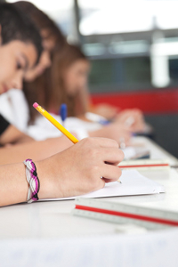 High School Students Writing At Desk